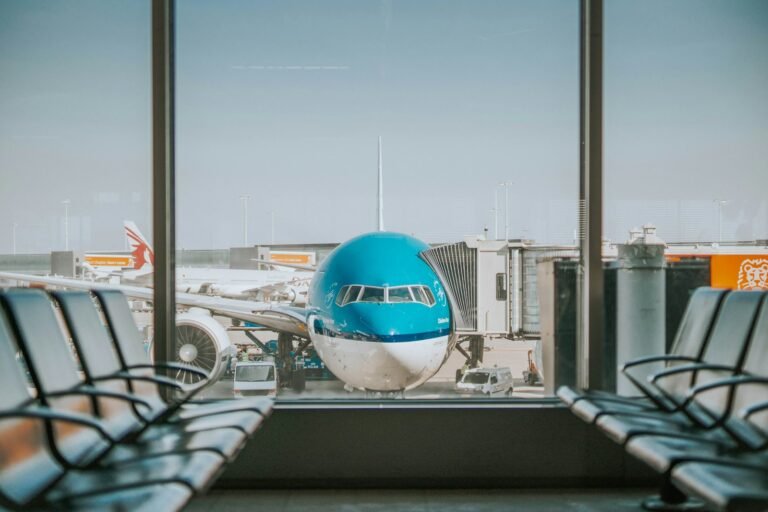Aircraft parked at an airport gate beside a passenger boarding bridge